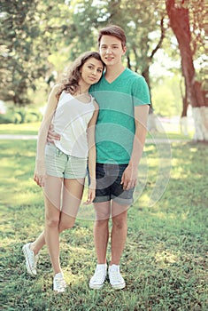 Vintage summer portrait modern couple teenagers in the park