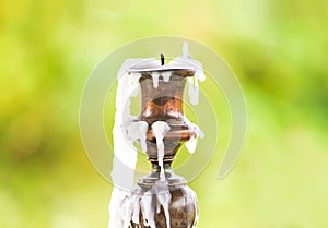 Vintage table candlestick with candle wax on blurred nature background