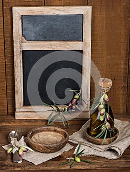 Vintage table setting with olives and and antique blackboard on