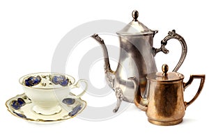 Vintage teapot, coffee pot and porcelain cup and saucer isolated on white. Collage