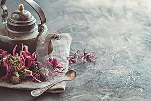 Vintage teapot of healthy echinacea tea and dry coneflower buds photo