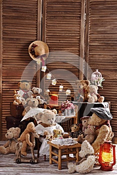 Vintage teddy bear family sitting at the tea table