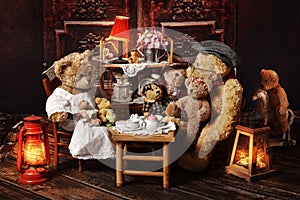 Vintage teddy bear family sitting at the tea table