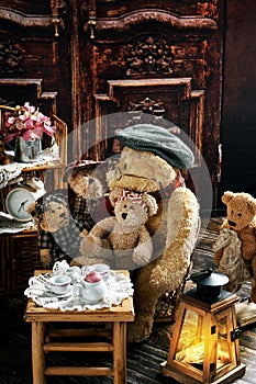 Vintage teddy bear family sitting at the tea table