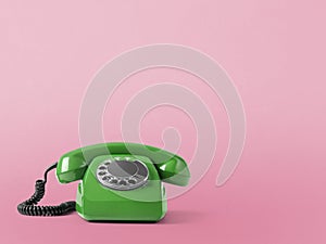 Vintage telephone on pink