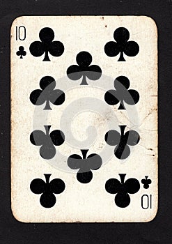 A vintage ten of clubs playing card on a black background.