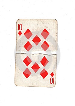 A vintage ten of diamonds playing card torn in half.