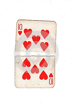 A vintage ten of hearts playing card torn in half.