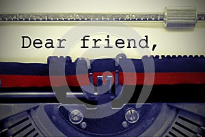 Vintage text DEAR FRIEND by the old typewriter on paper