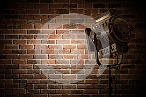 Vintage theater/movie spot light focused on a brick wall background