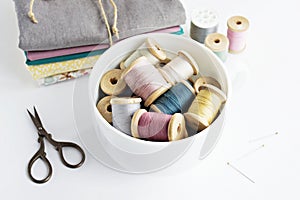 Vintage thread spools, scissors and cotton fabrics