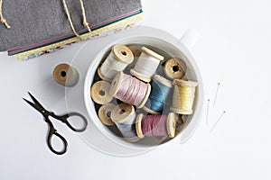 Vintage thread spools, scissors and cotton fabrics