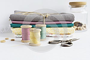 Vintage thread spools, wooden buttons, scissors and fabrics