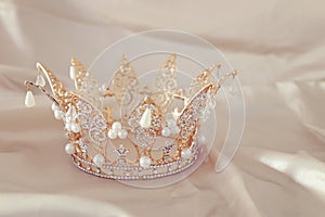 Vintage tiara over white delicate silk. Wedding concept