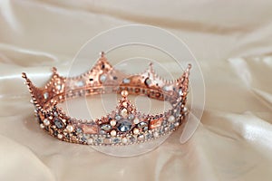 Vintage tiara over white delicate silk. Wedding concept