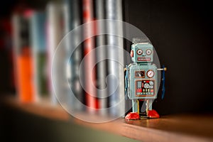 Vintage tin toy robot on a book shelf
