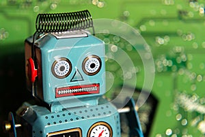 Vintage tin toy robot with computer board, artificial intelligence concept