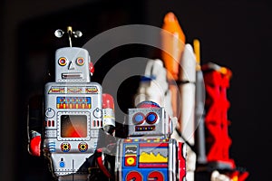 Vintage tin toy robot looking into the future of space exploration with rocket in background, artificial intelligence