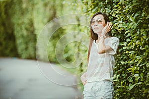 Vintage tone asian thin hipster girl wearing sunglasses outdoor