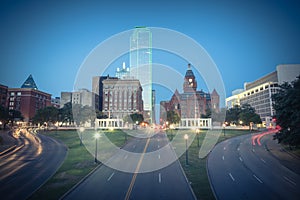 Vintage skyline and light trail traffic over Dealey Plaza in Dallas, Texas photo