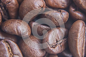 Vintage tone, soft focus close-up fresh roasted coffee beans