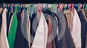 Vintage tone, teenager man's clothes hanging in wardrobe, selective focus