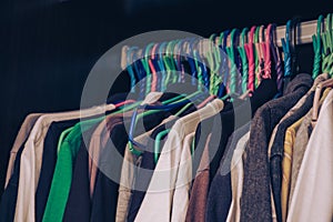 Vintage tone, teenager man's clothes hanging in wardrobe, selective focus