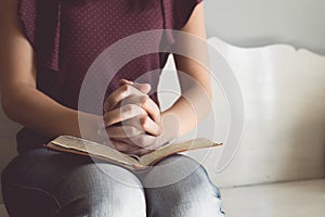 Vintage tone of woman hands on bible. she is reading and praying