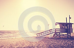 Vintage toned picture of lifeguard tower at sunset, Malibu.