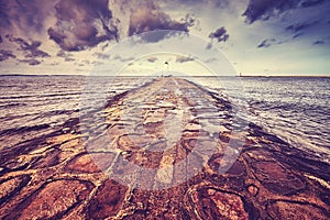 Vintage toned wide angle picture of windmill lighthouse.