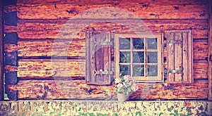 Vintage toned window of old wooden cottage.