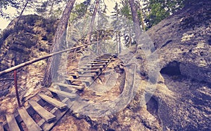 Vintage toned wooden ladder in Adrspach Teplice rock town.