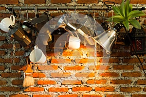 Vintage tones interior and decorations of a coffee shop, cafe. Vintage brown brick wall and hanging with making coffee materials.