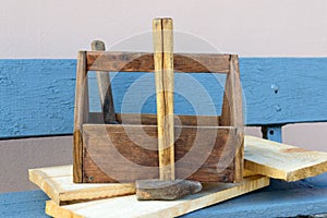 Vintage Toolbox with tools. Old wooden box with building tools, boards for repair on a wooden bench.