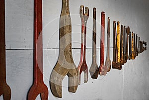 Vintage Tools Hung in Row on Wall