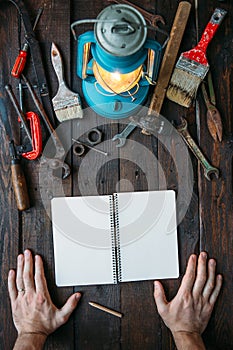 Vintage tools set on dark brown wooden background. Father's day concept. Hands in frame. Vertical holiday postcard, poster, banne