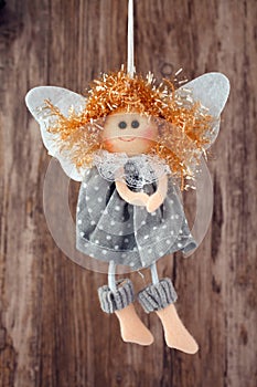 Vintage toy angel figurine on wooden table