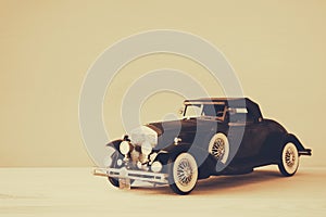 Vintage toy car over wooden table