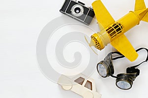 vintage toy plane, old photo camera and pilot glasses