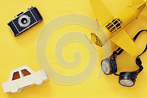 vintage toy plane, old photo camera and pilot glasses