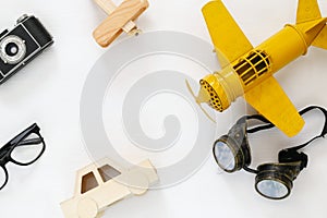 vintage toy plane, old photo camera and pilot glasses