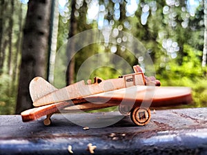Vintage toy wooden airplane in nature. Private adventure traveling by flight. Aircraft for nature protection, eco