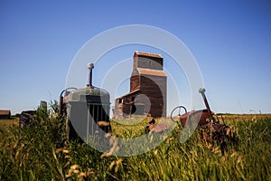 Vintage tractors in front of old grain elevator