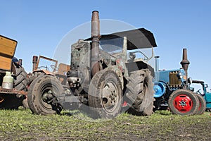 Vintage tractors from a low angle on a blue sky