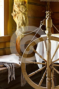 Vintage traditional spinning wheel, distaff with yarn in wooden