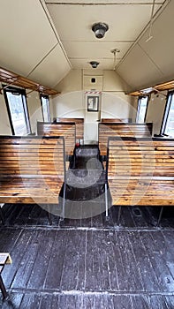 Vintage train with carriages at the station, view inside the carriage, wooden seats