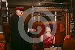 Vintage train conductor in old steam train