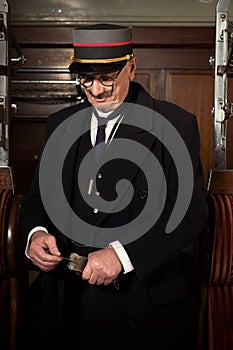 Vintage train conductor in Victorian train