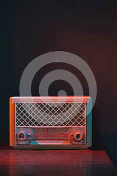 Vintage transistor radio on wooden table.