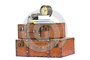 Vintage travel accessories - suitcases, clock, camera and books isolated on white background.